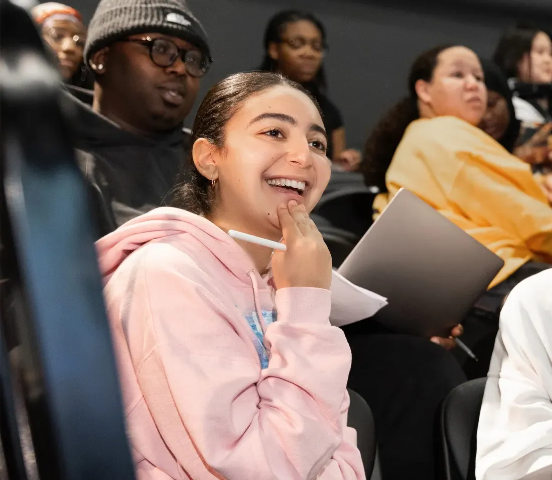 Tanisha Jackson sitting in class smiling.